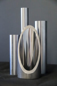 Close up of cut hydraulic cylinder tube and chrome bars on table